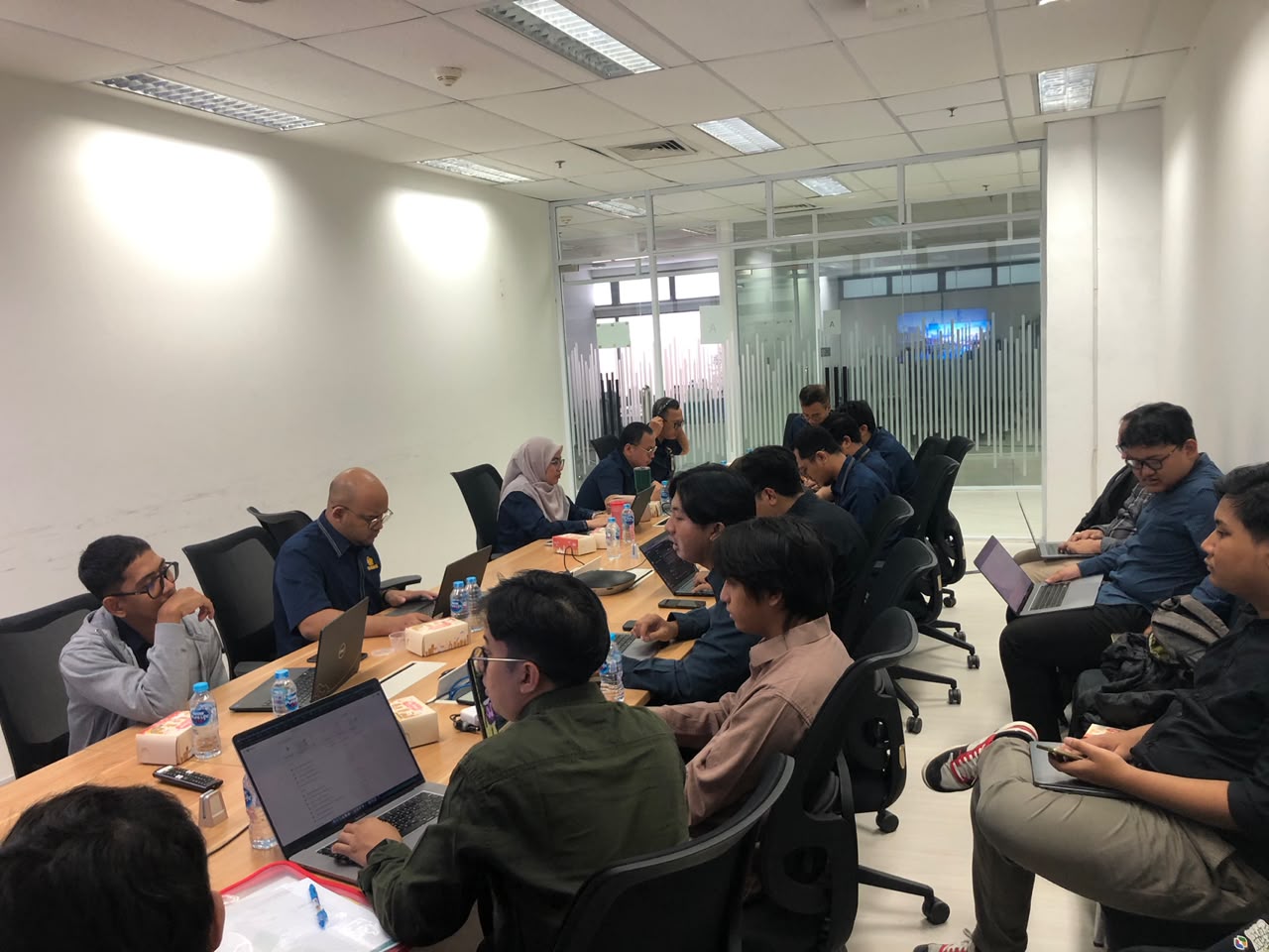 Engineering delivery session with laptops in a conference room